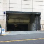 Full view of One Convention Place entrance with surrounding buildings