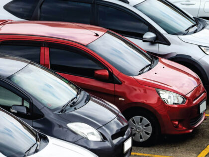 An image of cars parked at a retail center.