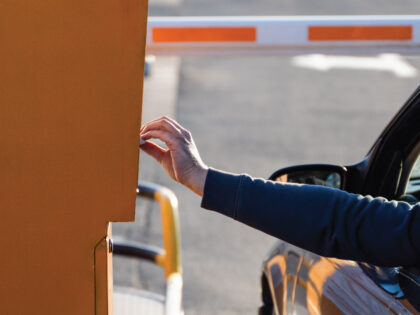 An image of someone getting a ticket to park in the parking garage.