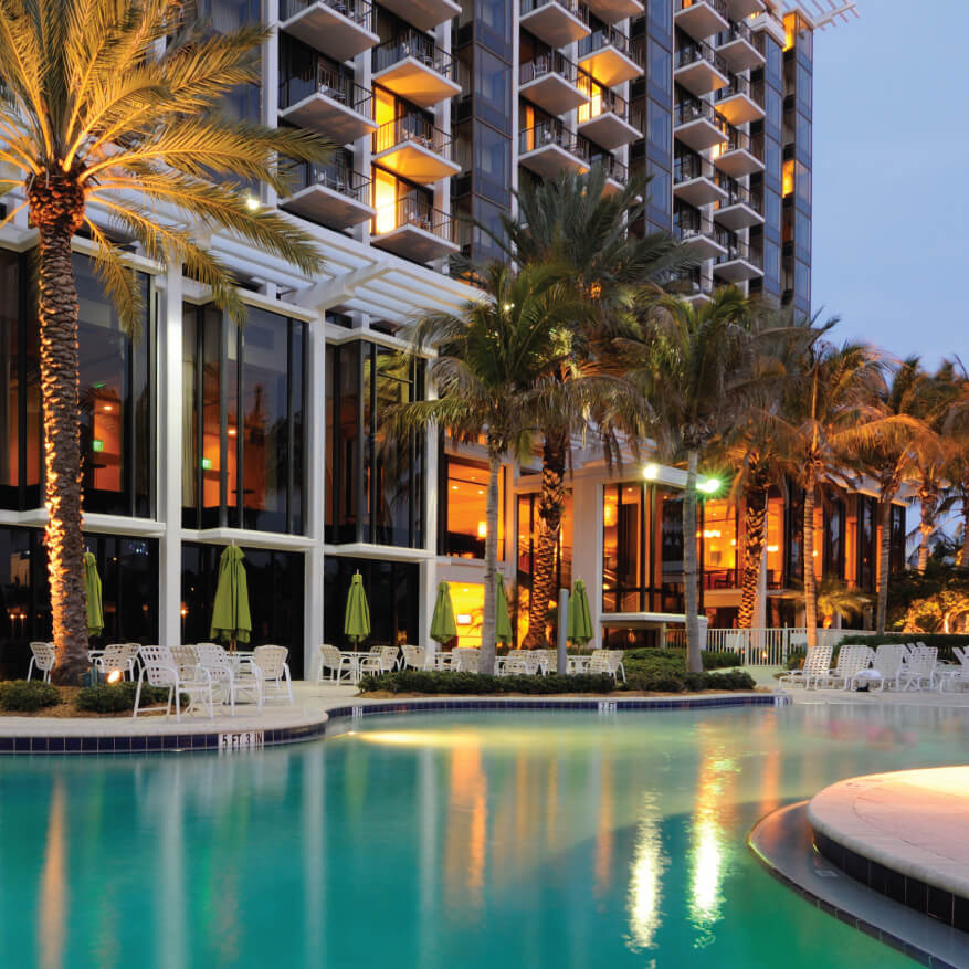 An image of a hotel pool at night.