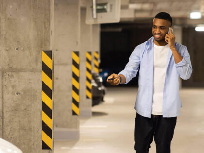 An image of someone walking to their car in the garage.